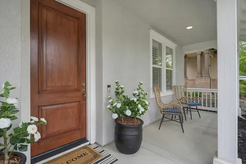 a view of a hallway with wooden floor and windows