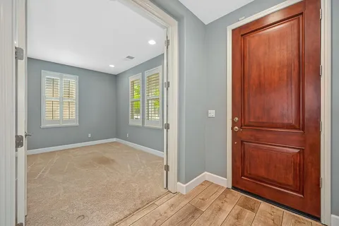 a view of a dining room with furniture chandelier and wooden floor