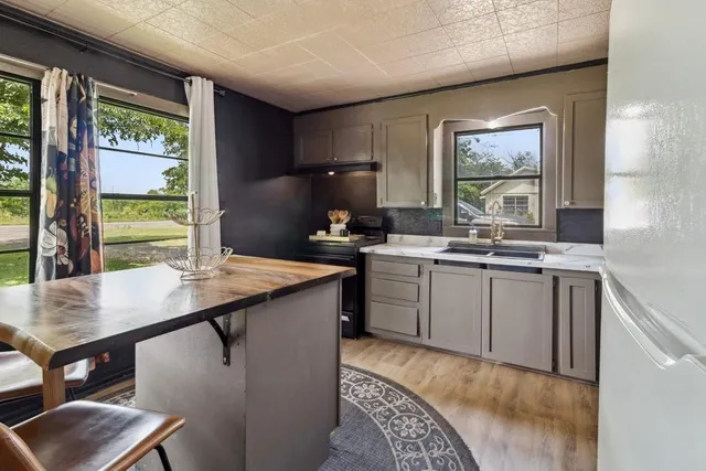 a kitchen with a sink stove and cabinets