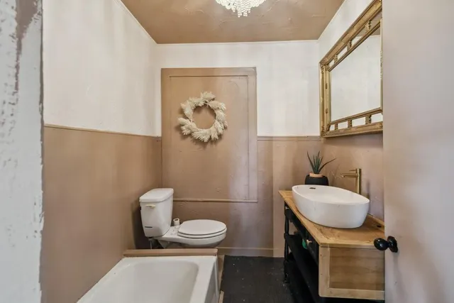 a bedroom with a bed and a ceiling fan