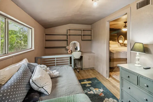 a bedroom with a bed and a table