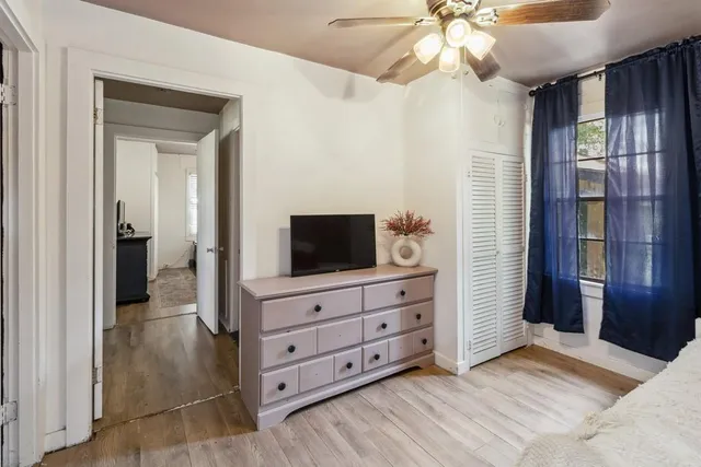a bedroom with two beds and a large window