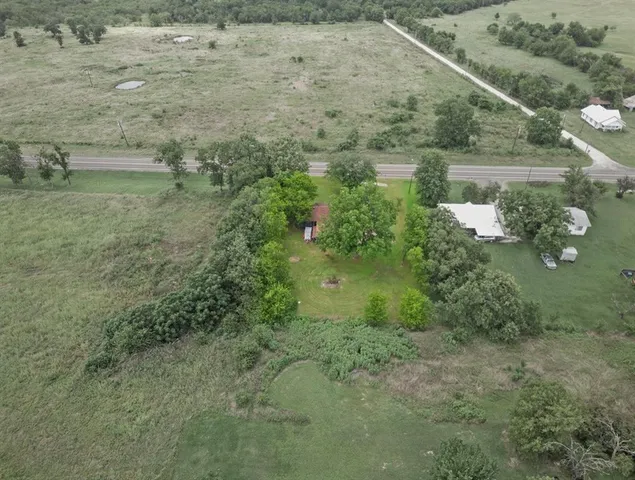 a view of a house with pool and a yard