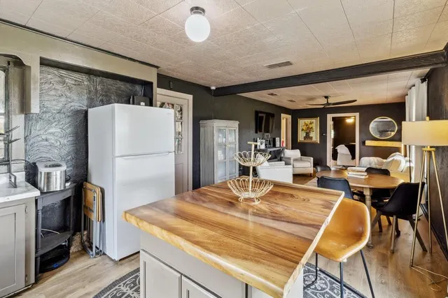 a kitchen with a sink cabinets and wooden floor
