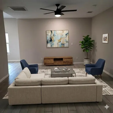 a living room with furniture and a potted plant