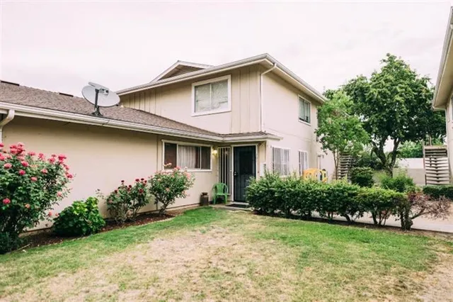 a front view of a house with garden