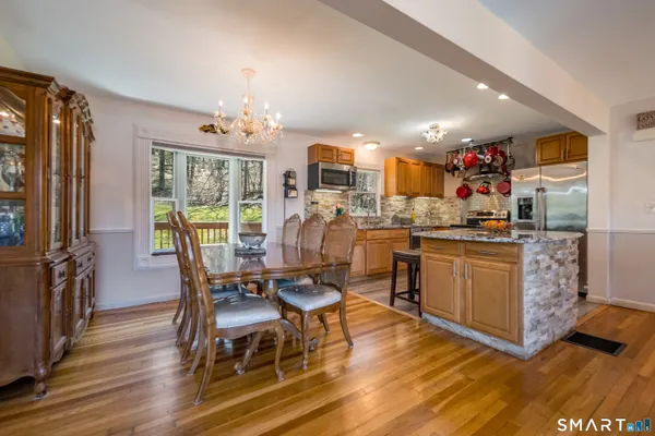 a kitchen with cabinets and wooden floor