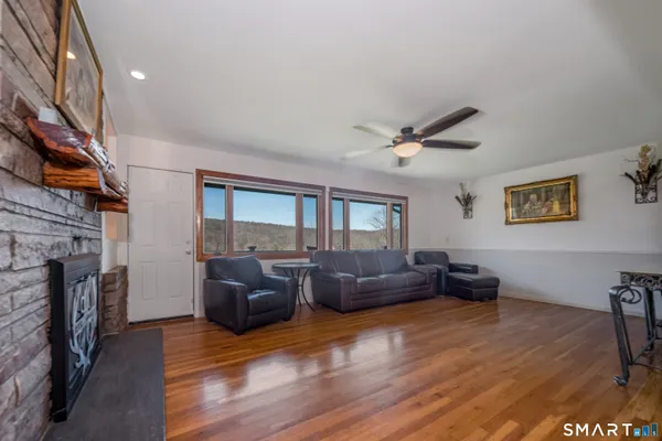 a living room with furniture fireplace and flat screen tv