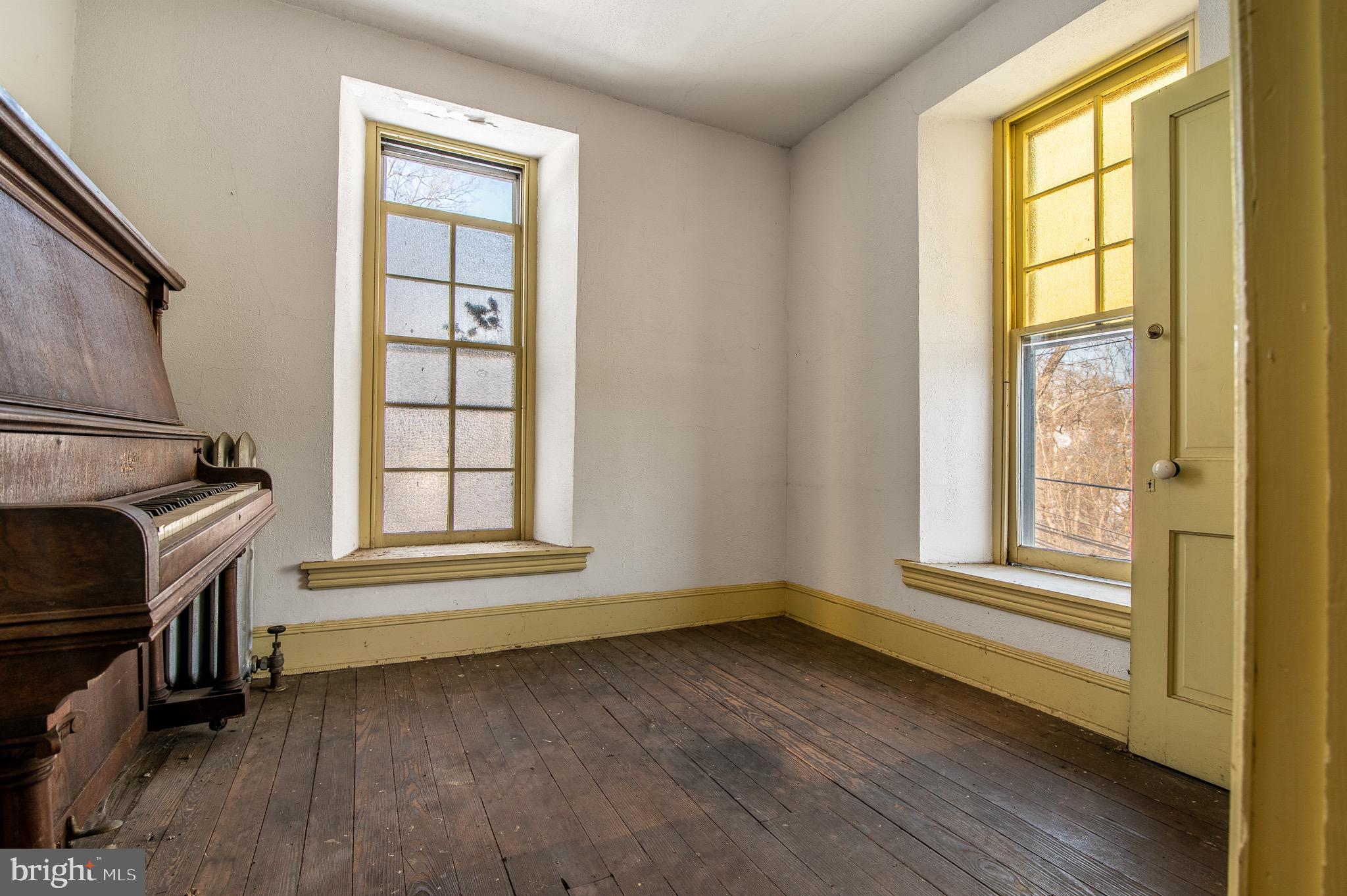 1638 Yellow Springs Road Chester Springs, PA 19425 - Photo 9 of 24 an empty room with wooden floor and windows