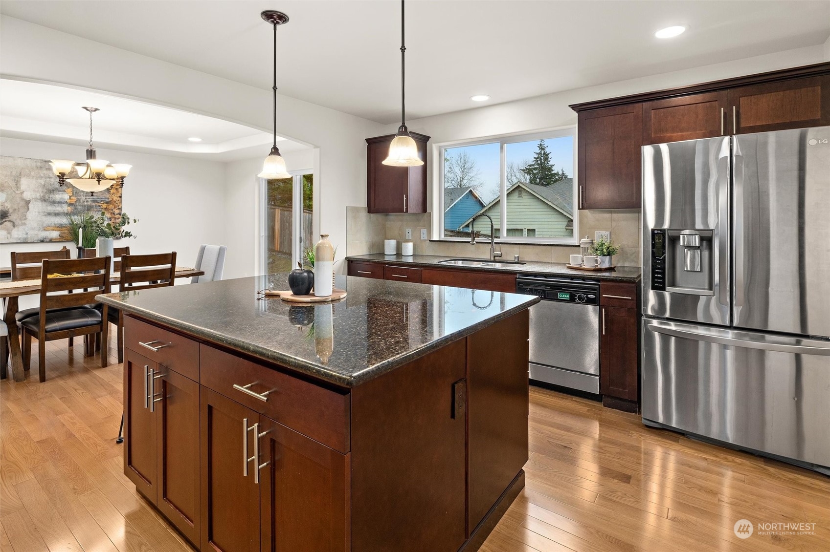 2205 239th Place Southwest Bothell, WA 98021 - Photo 22 of 40 a kitchen with stainless steel appliances granite countertop a sink a stove and a refrigerator