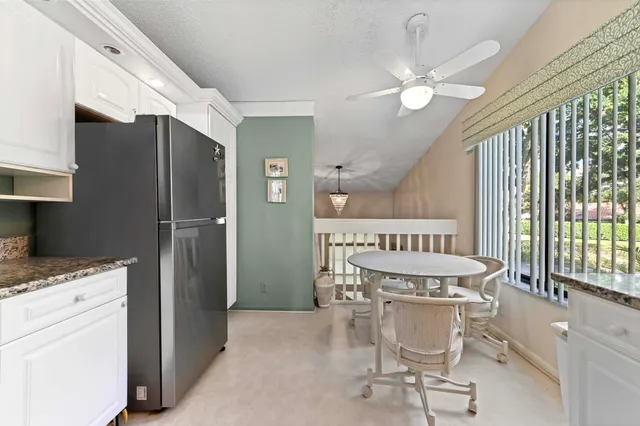 a kitchen with stainless steel appliances granite countertop a stove top oven a sink dishwasher a refrigerator and a microwave oven