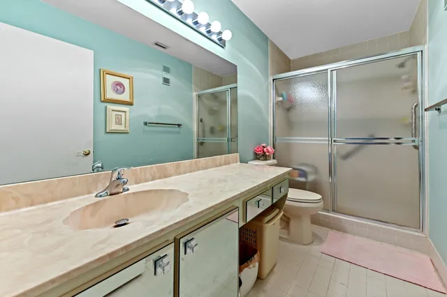 a spacious bedroom with a bed and a flat screen tv