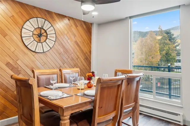 a dining room with furniture garden view and a large window