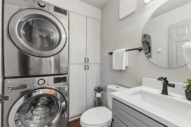 a bathroom with a sink a washer and dryer