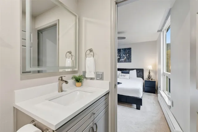 a en suite bathroom with a sink and a mirror