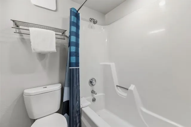 a bathroom with a toilet and a bathtub