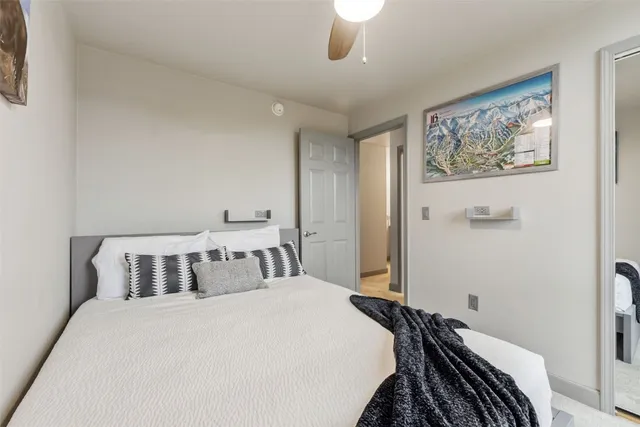 a bedroom with a bed and a painting on the wall