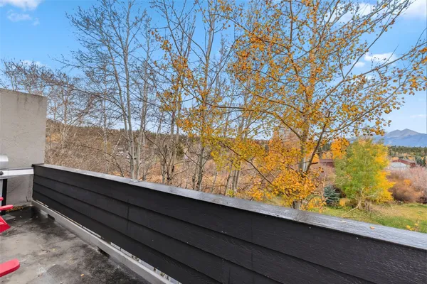 a balcony with table and chairs