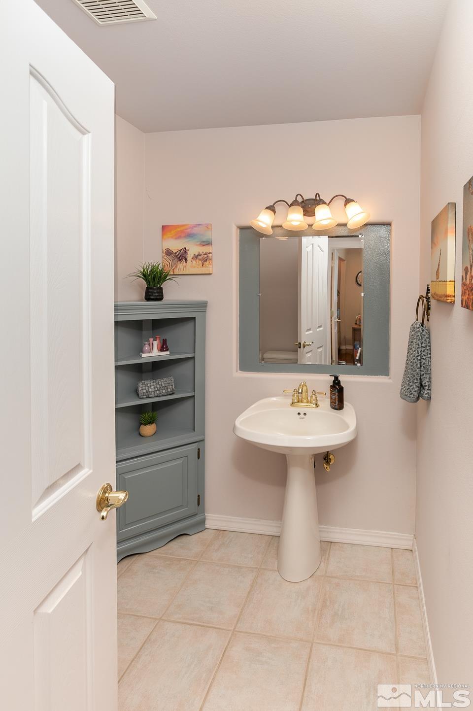 5275 Rivers Edge Drive Fallon, NV 89406 - Photo 12 of 36 a bathroom with a sink a toilet and mirror