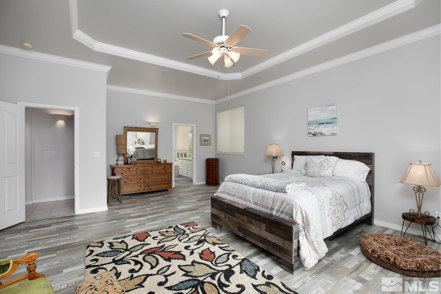 5275 Rivers Edge Drive Fallon, NV 89406 - Photo 18 of 36 a bedroom with bed and a chandelier