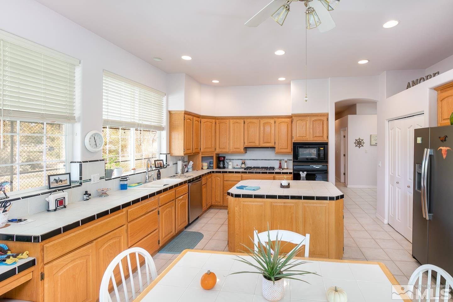 5275 Rivers Edge Drive Fallon, NV 89406 - Photo 2 of 36 a kitchen with stainless steel appliances granite countertop a sink a stove and a refrigerator