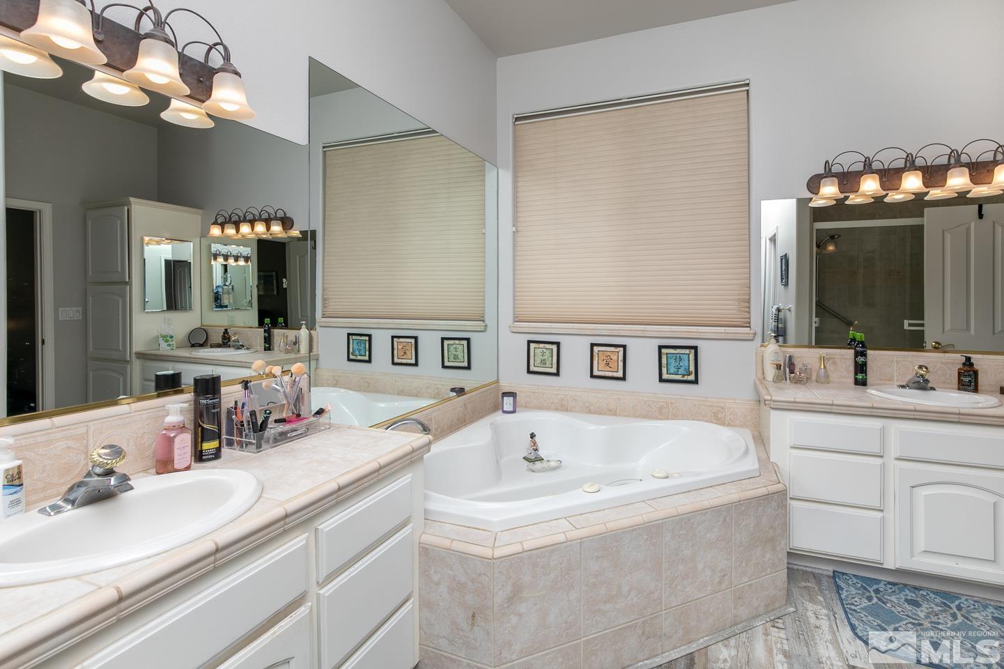 5275 Rivers Edge Drive Fallon, NV 89406 - Photo 21 of 36 a bathroom with a tub sink and mirror