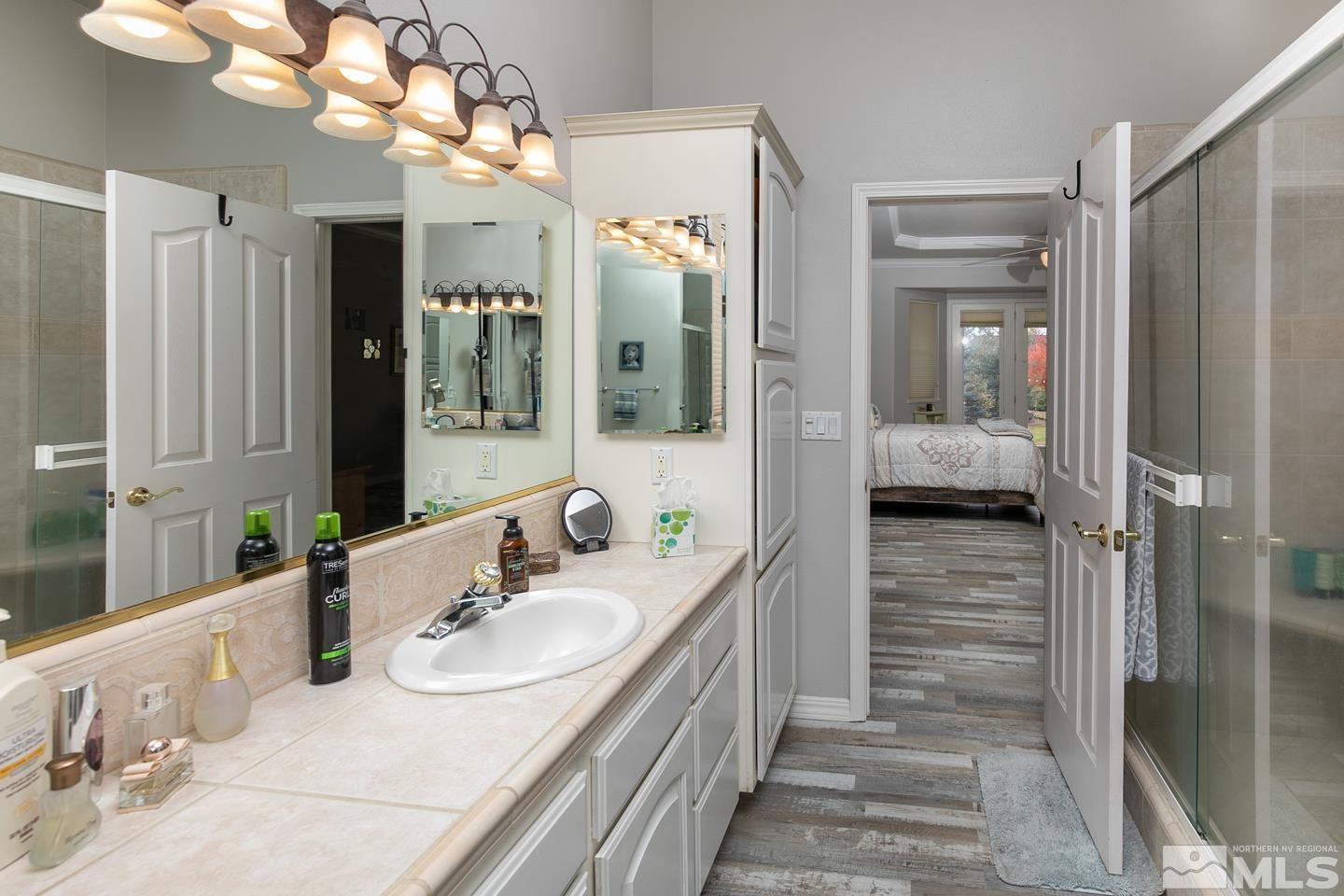 5275 Rivers Edge Drive Fallon, NV 89406 - Photo 22 of 36 a bathroom with a sink a mirror and a shower