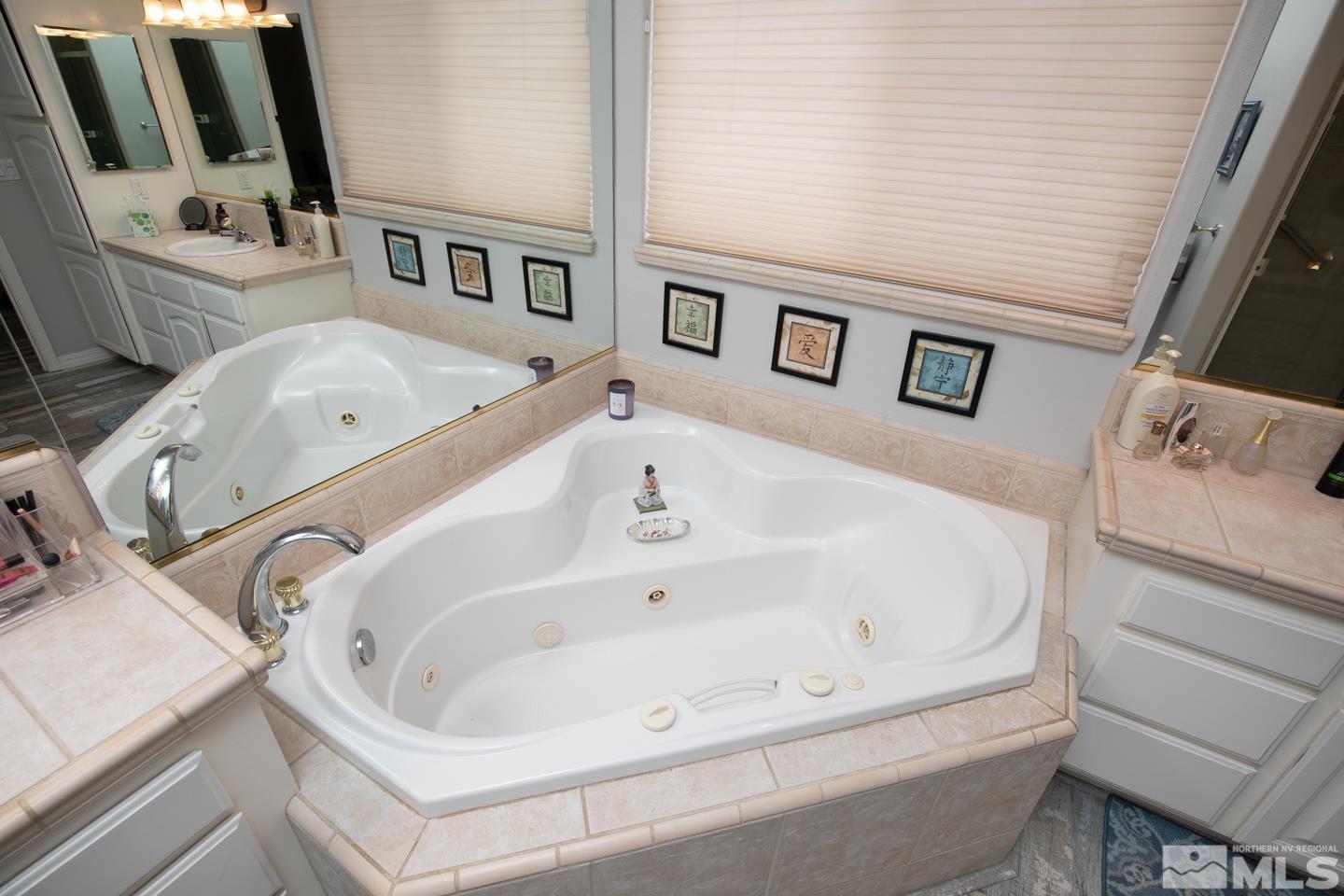 5275 Rivers Edge Drive Fallon, NV 89406 - Photo 23 of 36 a bathroom with a tub sink and mirror