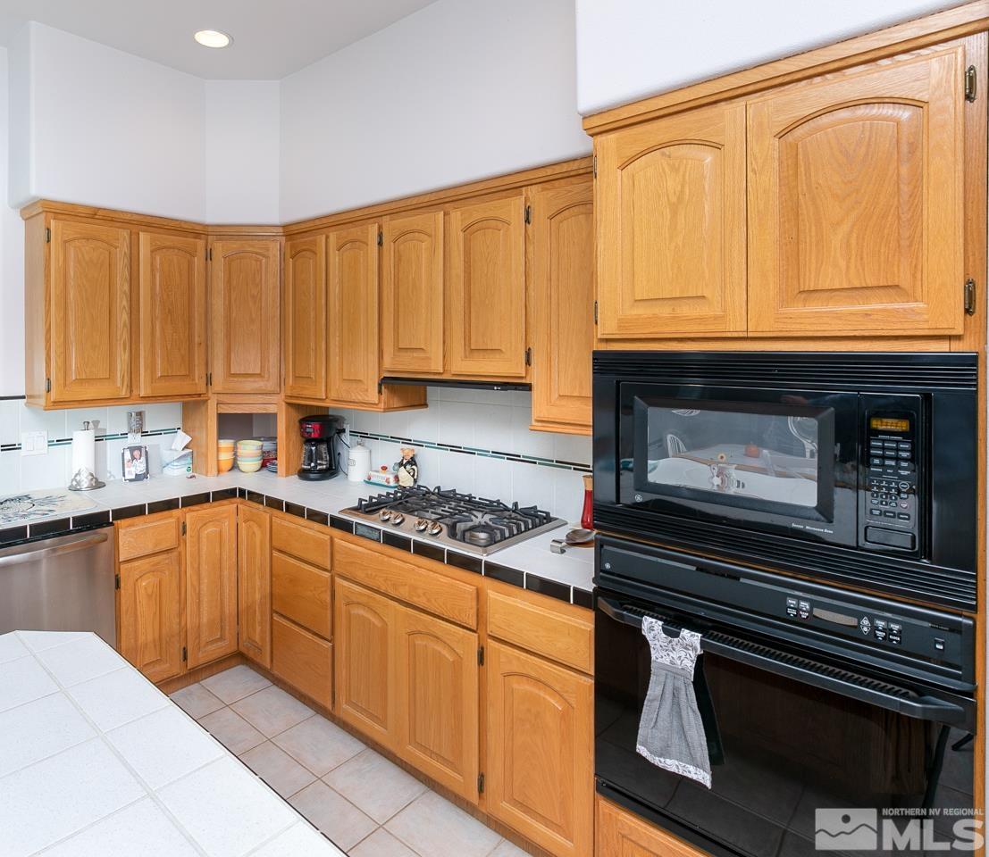 5275 Rivers Edge Drive Fallon, NV 89406 - Photo 6 of 36 a kitchen with stainless steel appliances granite countertop a stove and cabinets