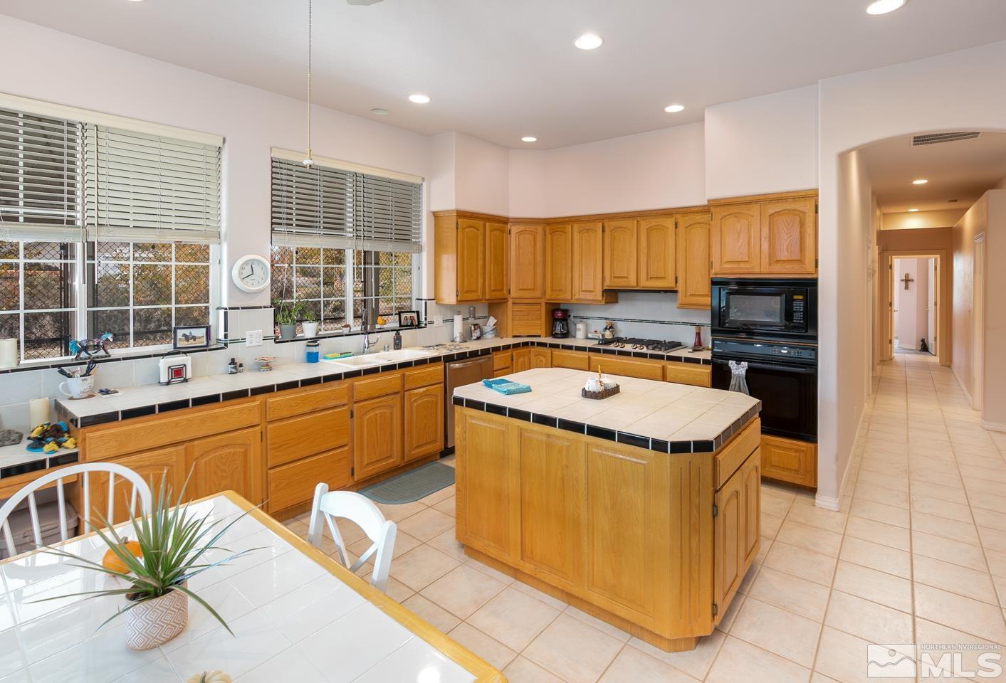 5275 Rivers Edge Drive Fallon, NV 89406 - Photo 7 of 36 a kitchen with a refrigerator a sink and a counter top space