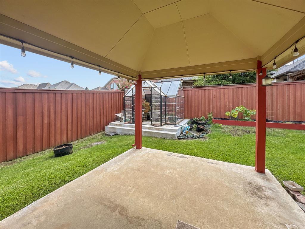 3205 Ridgeway Drive McKinney, TX 75071 - Photo 25 of 27 a view of a backyard with potted plants and wooden fence