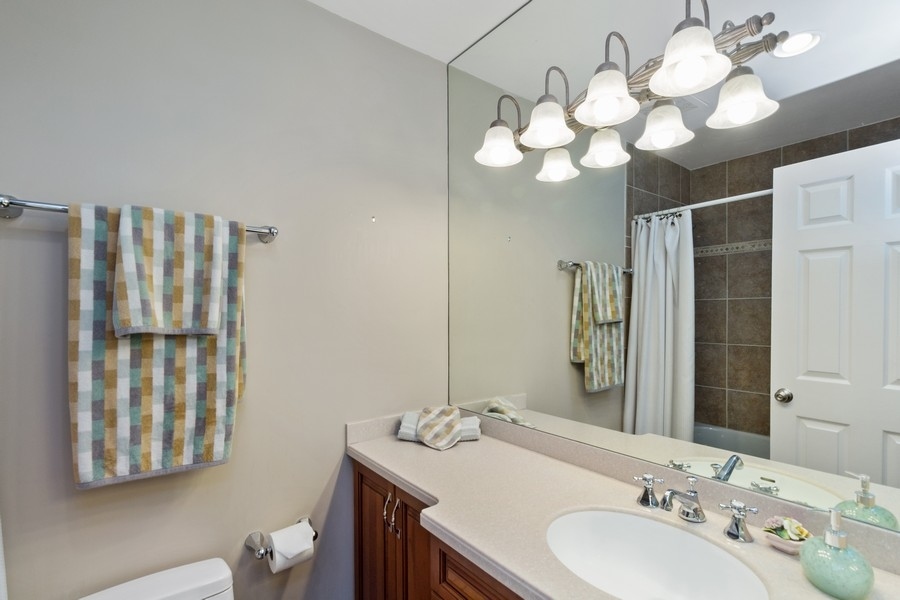 1164 Devonshire Road Buffalo Grove, IL 60089 - Photo 13 of 20 a bathroom with a sink a vanity and a mirror