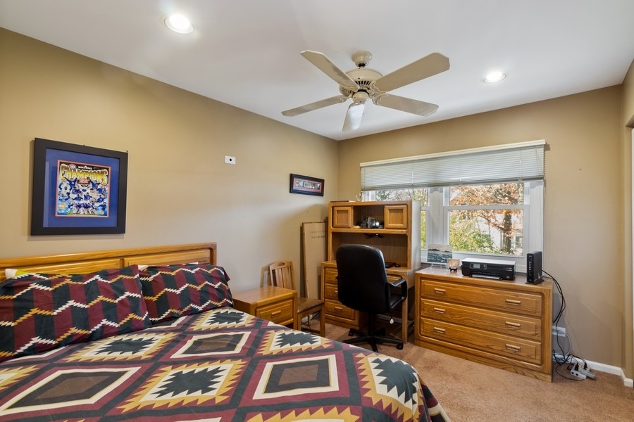 1164 Devonshire Road Buffalo Grove, IL 60089 - Photo 15 of 20 a bedroom with a bed and a chandelier