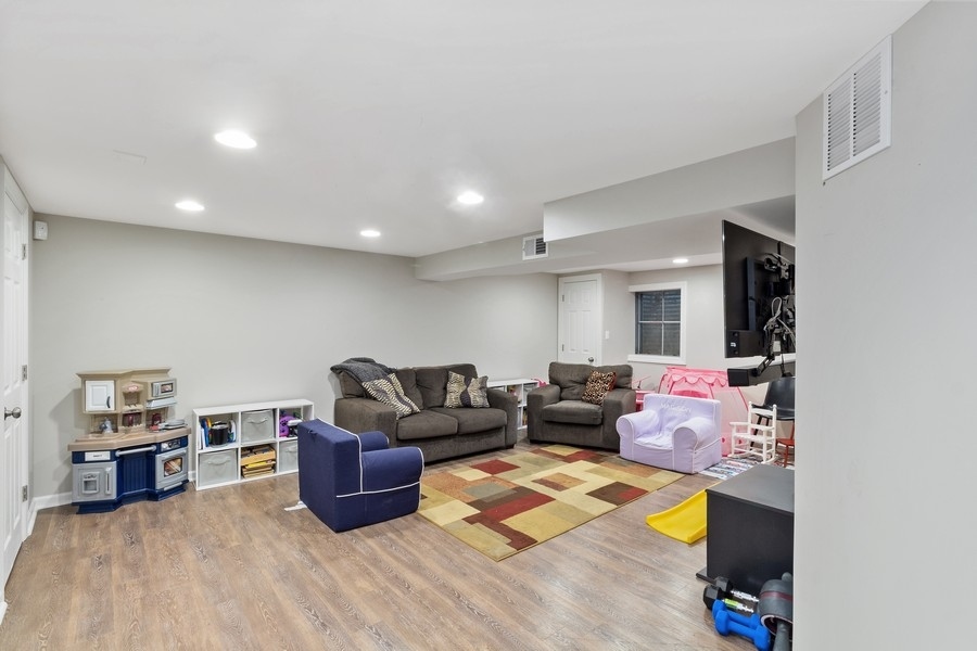 1164 Devonshire Road Buffalo Grove, IL 60089 - Photo 16 of 20 a living room with furniture and a wooden floor