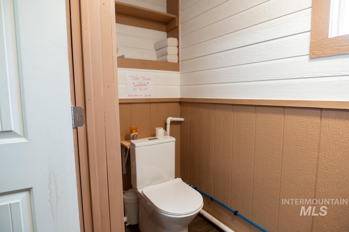 736 East Main Street Weiser, ID 83672 - Photo 10 of 33 Bathroom with wood walls and toilet