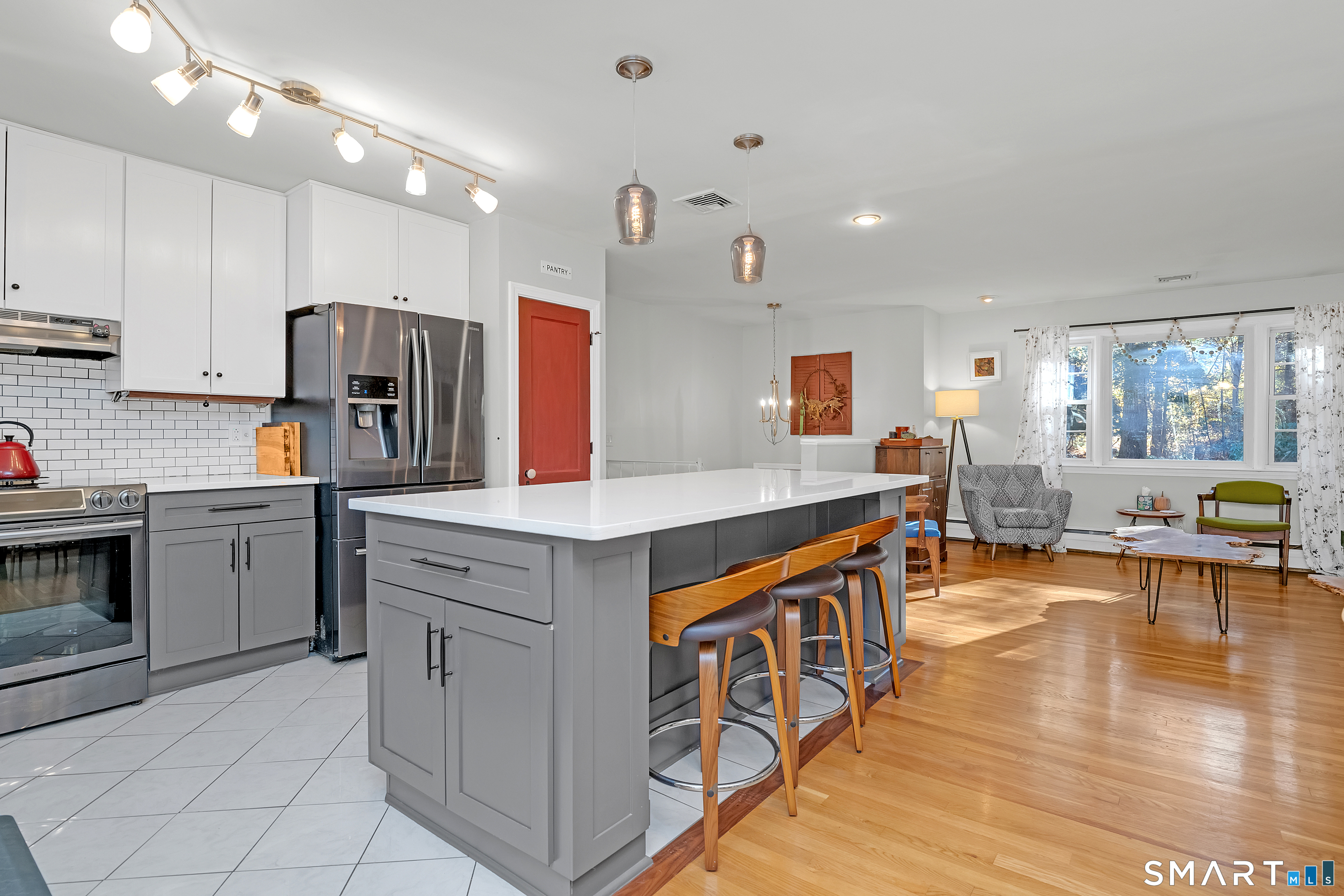 16 Marion Road Bethany, CT 06524 - Photo 9 of 40 a kitchen with stainless steel appliances granite countertop a stove top oven a sink dishwasher a dining table and chairs with wooden floor