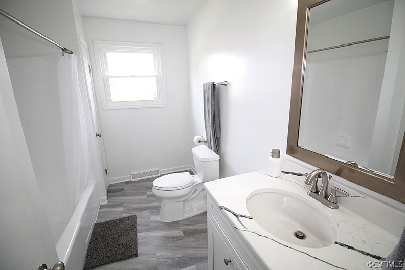 6440 Commander Road Richmond, VA 23224 - Photo 12 of 20 a bathroom with a sink toilet and shower