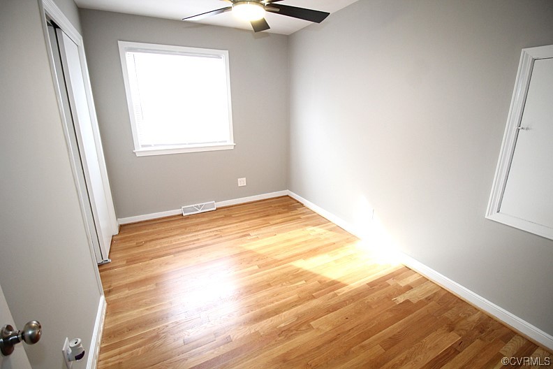 6440 Commander Road Richmond, VA 23224 - Photo 13 of 20 an empty room with wooden floor and windows