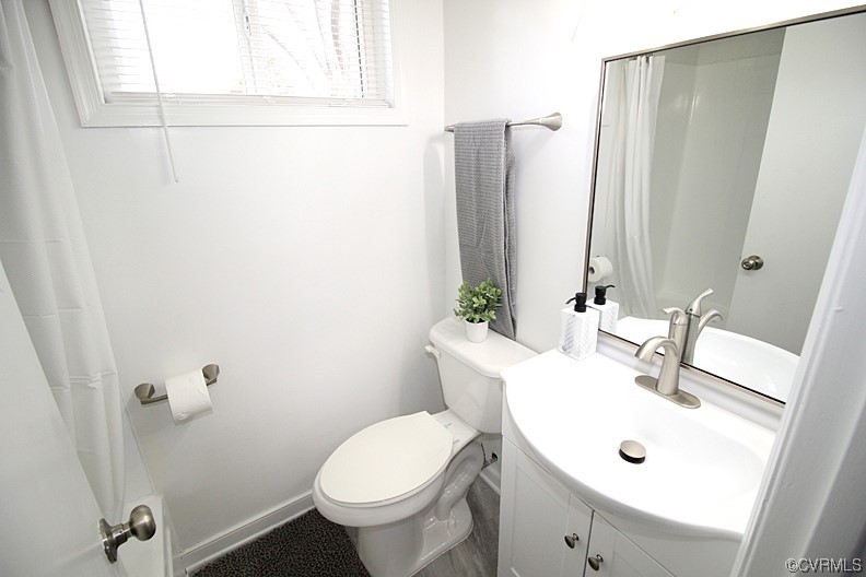 6440 Commander Road Richmond, VA 23224 - Photo 17 of 20 a bathroom with a sink mirror and toilet