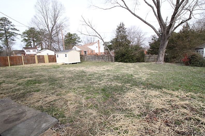 6440 Commander Road Richmond, VA 23224 - Photo 4 of 20 a white house that has a tree in front of it
