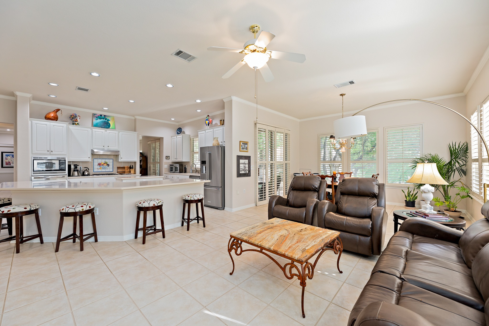 106 Wild Turkey Lane Georgetown, TX 78633 - Photo 16 of 39 a living room with lots of white furniture and a chandelier