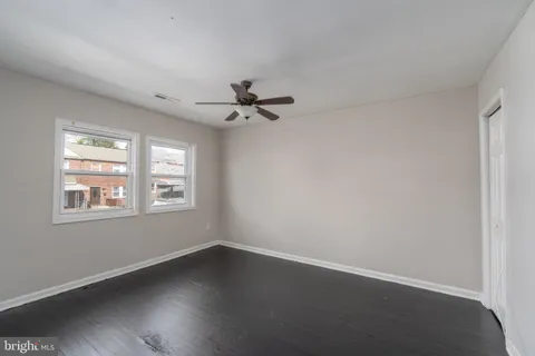 a view of a livingroom with a hardwood floor and a ceiling fan