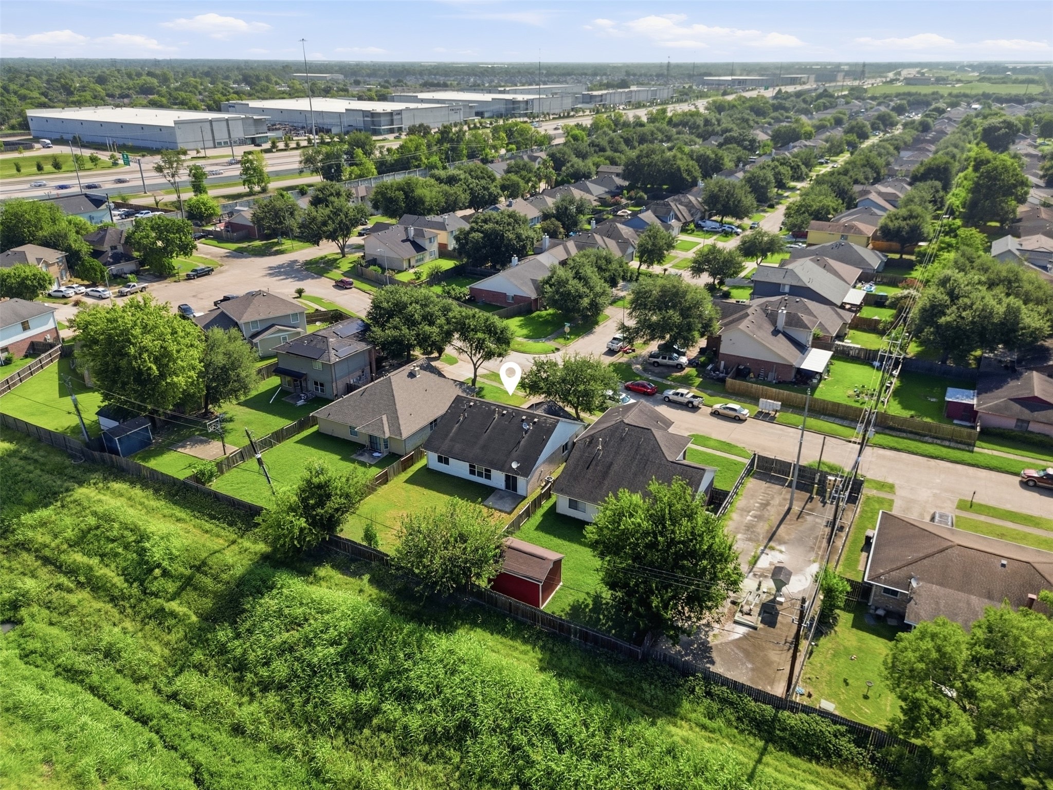 15738 Boonridge Road Houston, TX 77053 - Photo 29 of 31 Charming suburban neighborhood with neatly arranged homes and lush green lawns, offering a peaceful residential setting near convenient amenities.