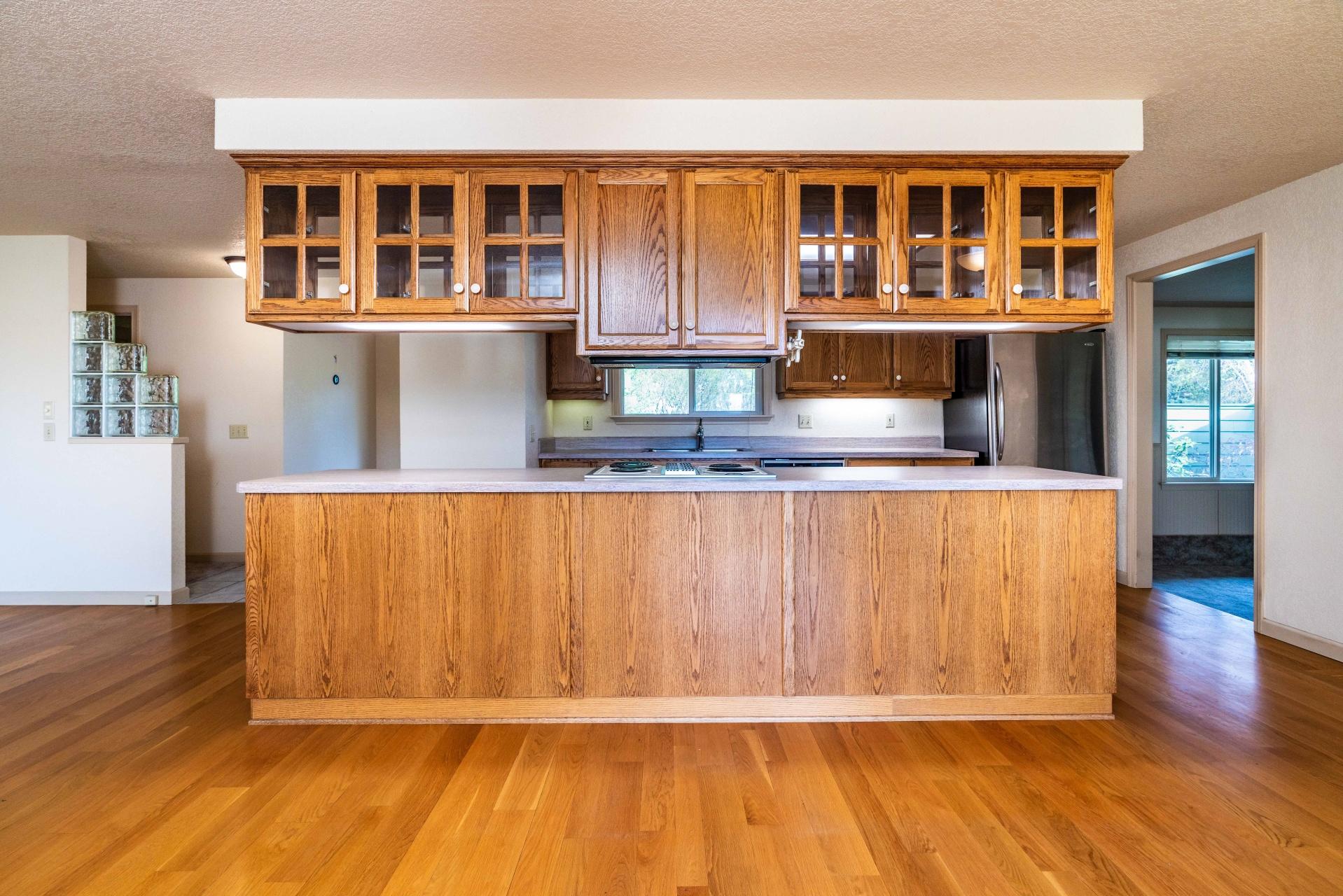 61919 Dobbin Road Bend, OR 97702 - Photo 7 of 57 a view of kitchen with wooden floor and cabinets
