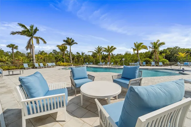 a view of a patio with couches table and chairs and potted plants