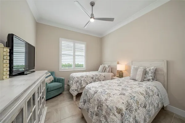 a bedroom with two beds and a couch