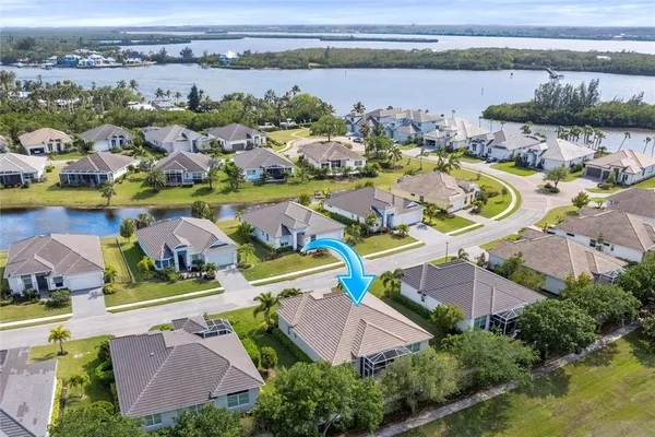 an aerial view of house with yard swimming pool and ocean view