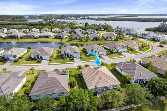 an aerial view of residential houses with outdoor space and swimming pool