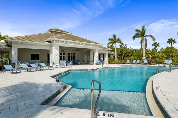 a view of a house with swimming pool and porch with furniture