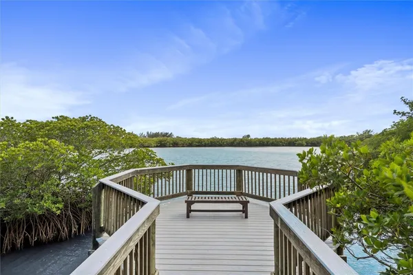 a balcony with wooden floor and city view